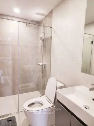 Modern bathroom with sleek fixtures and glass shower enclosure