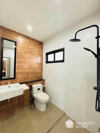 Modern bathroom with sleek fixtures and wood panel accents