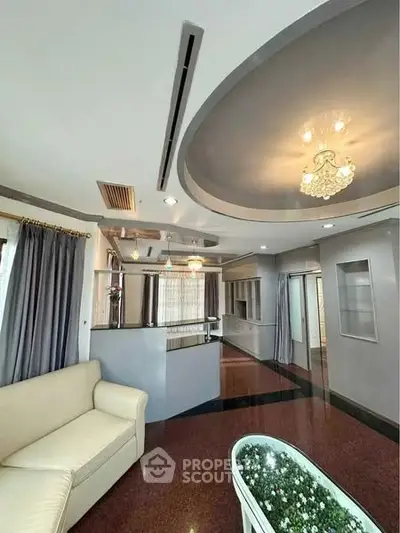 Luxurious living room with elegant ceiling design and plush seating