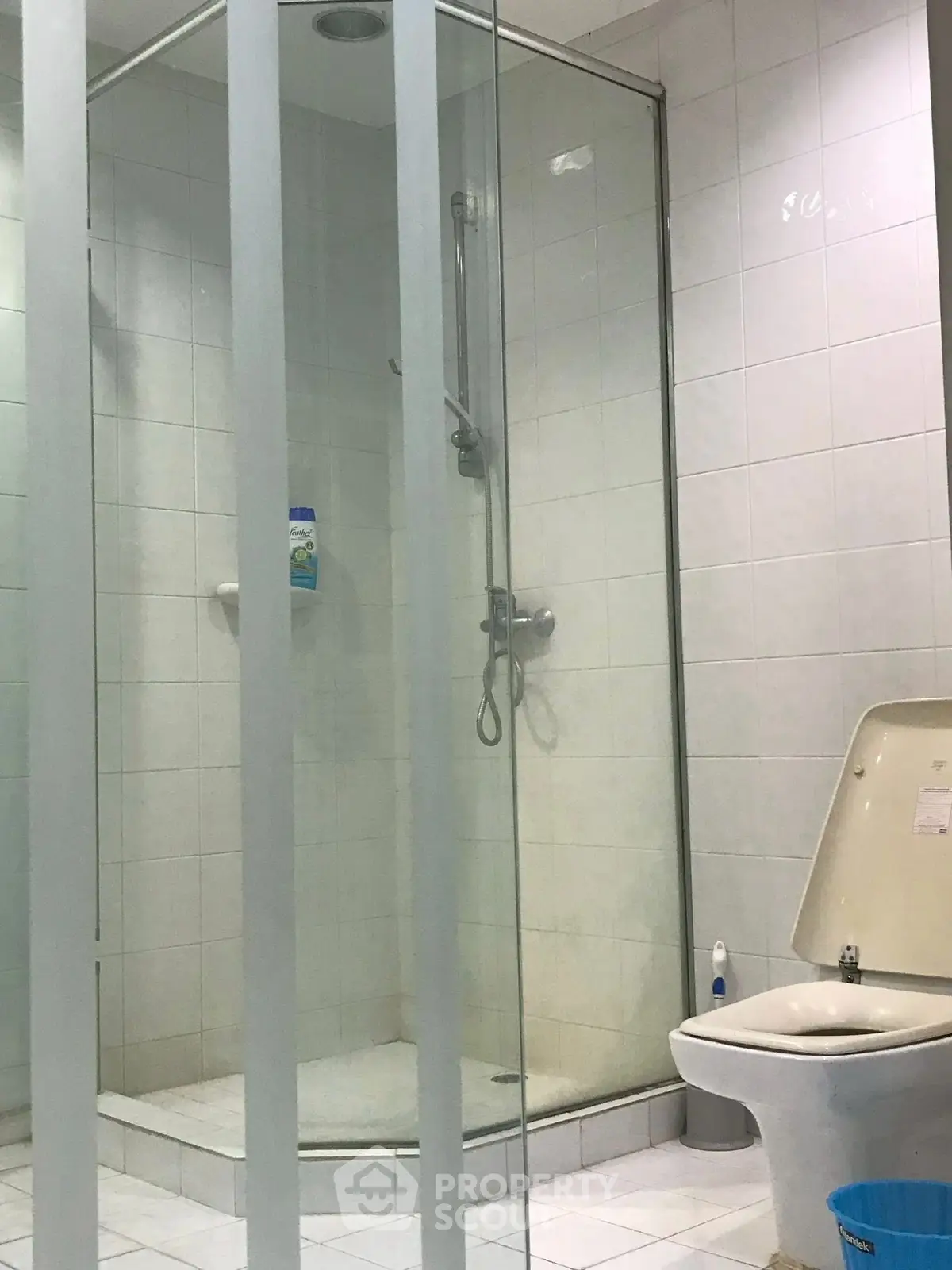 Modern bathroom with glass shower and white tiles