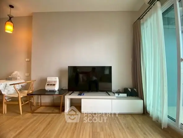 Modern living room with sleek TV setup and natural light