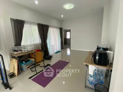 Spacious multi-purpose room with exercise equipment and natural light