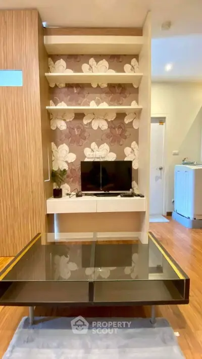 Stylish living room with modern TV setup and floral accent wall