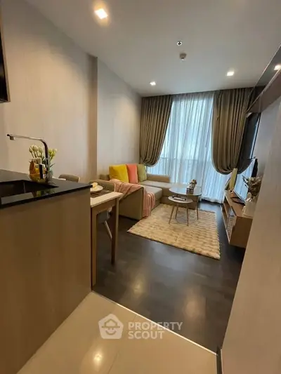 Modern living room with cozy seating and stylish decor in a contemporary apartment.