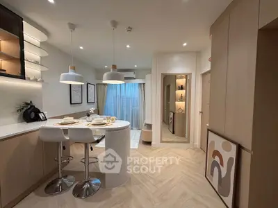 Modern open-plan kitchen and dining area with stylish decor and warm lighting.