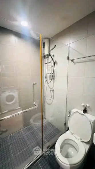 Modern bathroom with glass shower enclosure and sleek fixtures