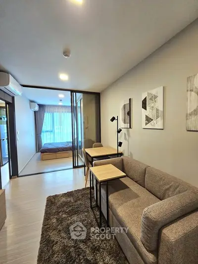 Modern living room with cozy sofa and stylish decor in open-plan apartment