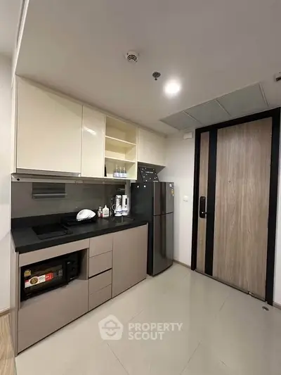 Modern kitchen with sleek cabinetry and appliances in a contemporary apartment.