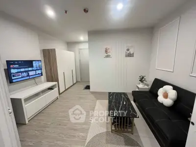 Modern living room with sleek furniture and wall-mounted TV, perfect for contemporary urban living.