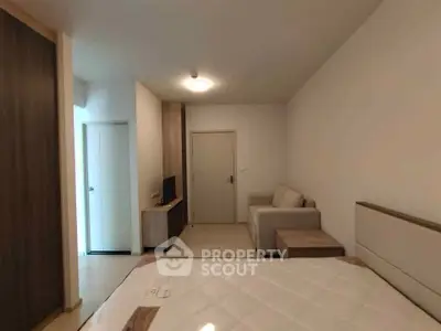 Modern bedroom with cozy sofa and minimalist decor