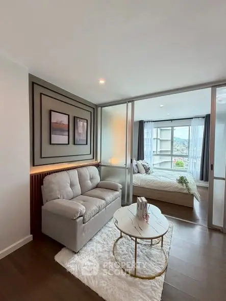 Modern living room with cozy sofa and elegant bedroom view