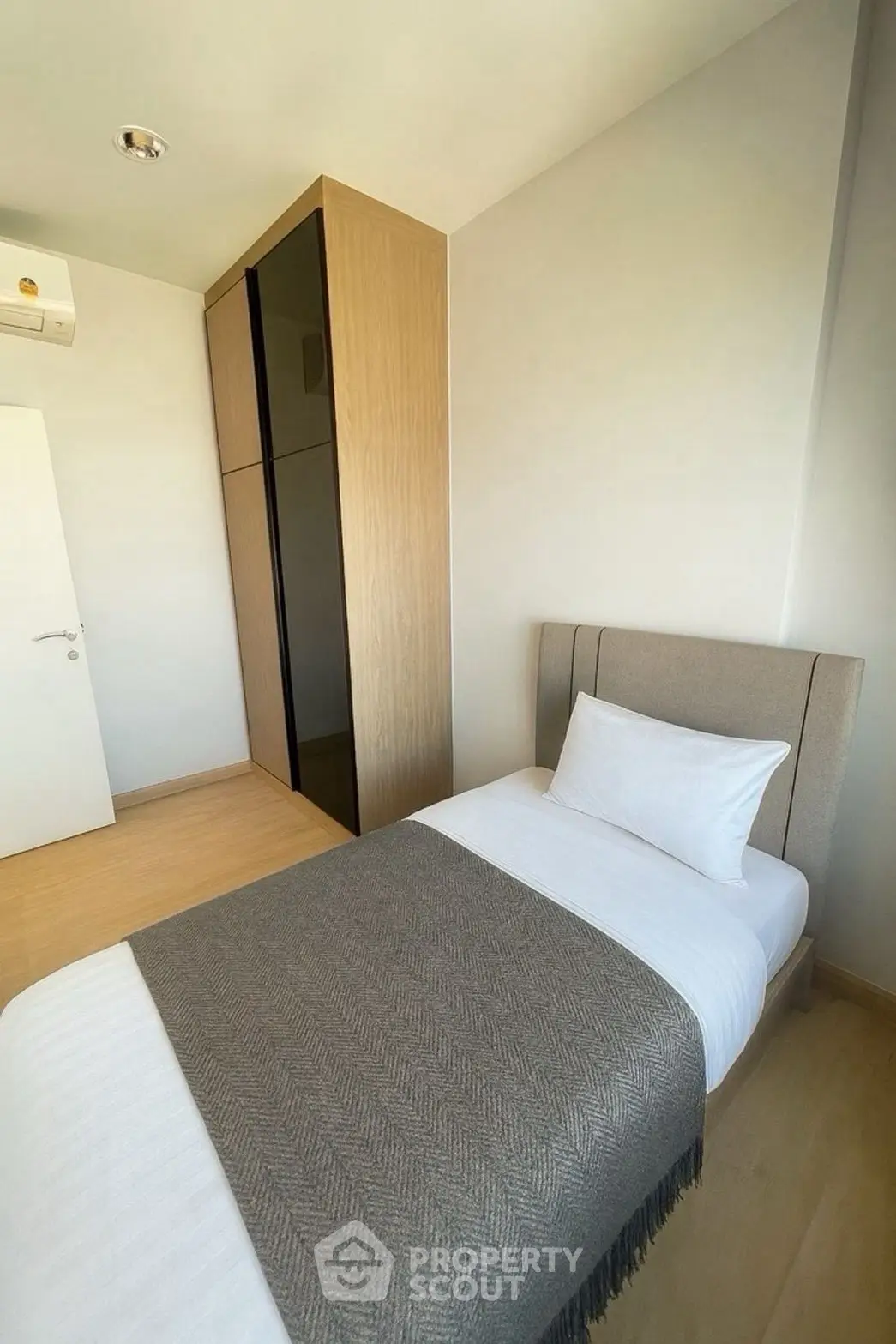 Cozy minimalist bedroom with single bed and modern wardrobe