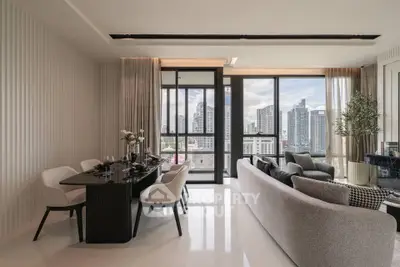 Luxurious modern living room with city view, elegant dining area, and stylish decor in high-rise apartment.