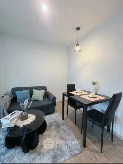 Modern living room with cozy sofa and dining area, perfect for urban living.