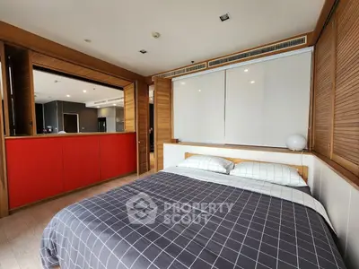 Modern bedroom with stylish decor and open kitchen view