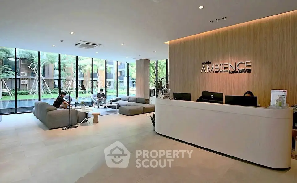 Luxurious lobby with modern design and large windows overlooking a serene garden view.