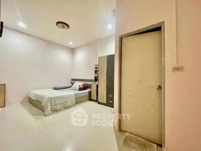 Spacious bedroom with modern furnishings and ample lighting, perfect for relaxation and comfort.