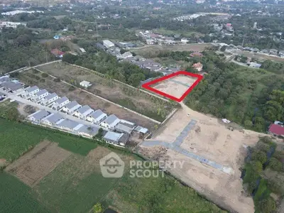 Aerial view of residential development with marked plot of land for sale.