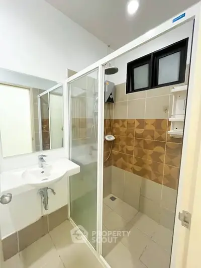 Modern bathroom with stylish shower and sink in contemporary apartment.