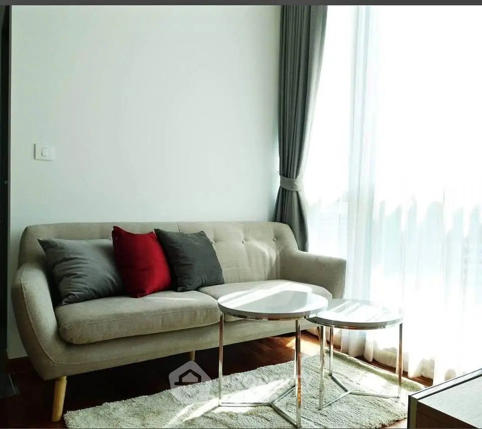 Stylish living room with modern sofa and elegant curtains, perfect for cozy relaxation.