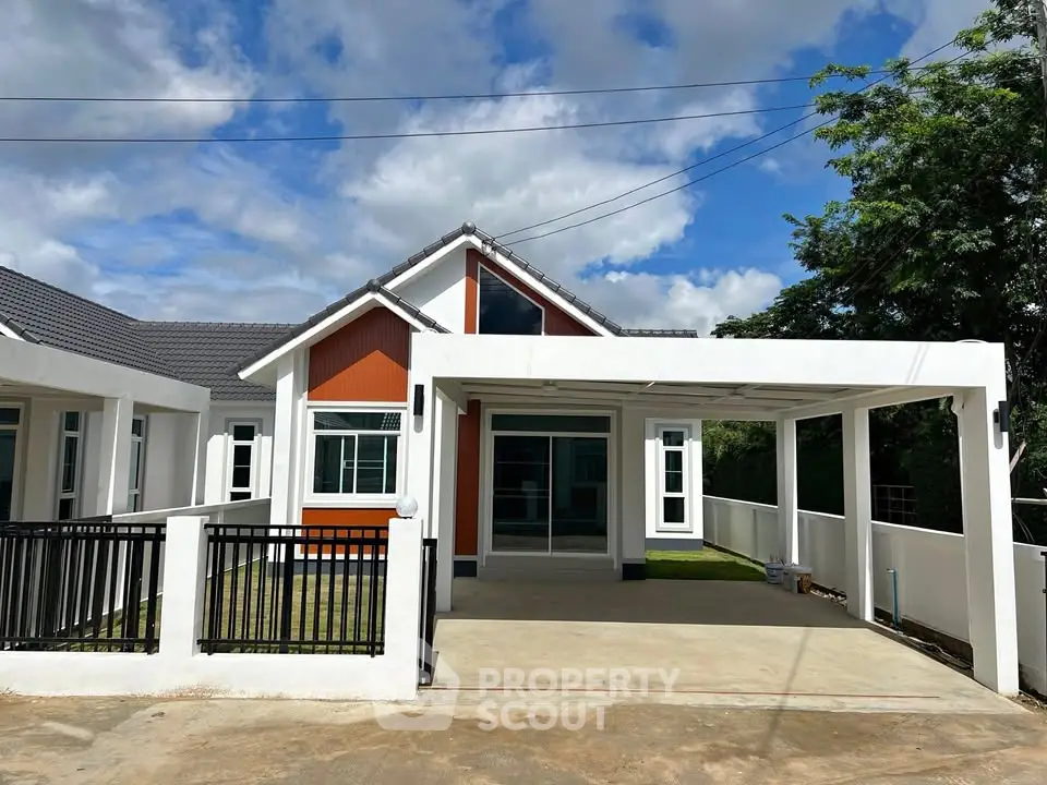 Charming modern house with spacious driveway and sleek design under a vibrant blue sky.