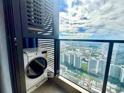 Stunning high-rise balcony with cityscape view and modern washing machine.