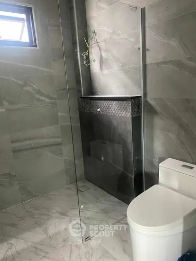 Modern bathroom with sleek glass shower and marble tiles