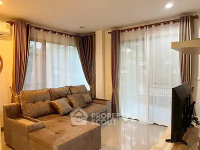 Spacious living room with modern sofa and large windows for natural light