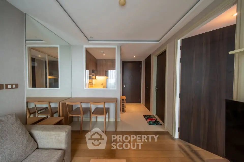 Modern living room with wooden flooring and stylish furniture in a contemporary apartment.