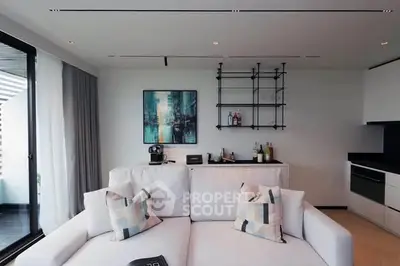 Modern living room with sleek design and balcony view, featuring stylish furniture and contemporary decor.