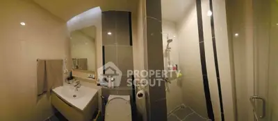 Modern bathroom with sleek fixtures and spacious shower area