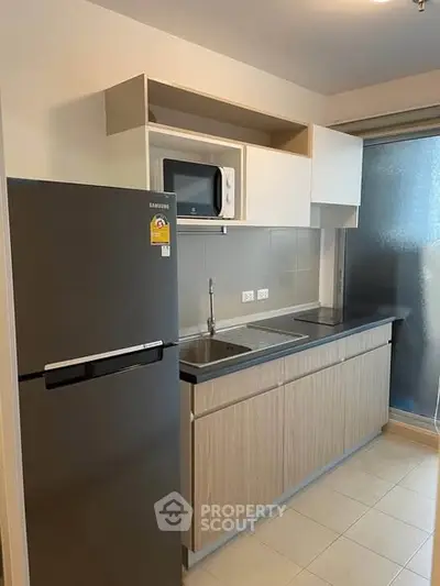 Modern kitchen with sleek cabinetry and stainless steel appliances in a compact layout.