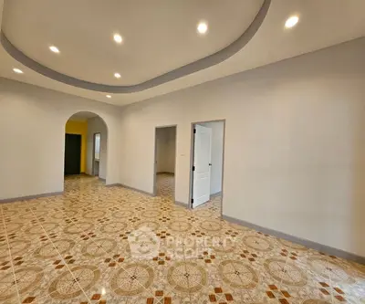 Spacious interior with elegant tile flooring and modern lighting, perfect for versatile living space.