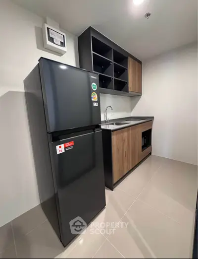 Modern kitchen with sleek black fridge and stylish cabinetry