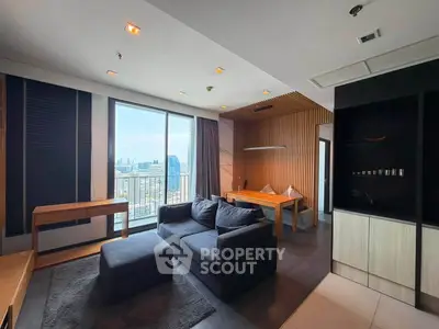 Modern living room with city view, featuring sleek furniture and stylish decor in a high-rise apartment.