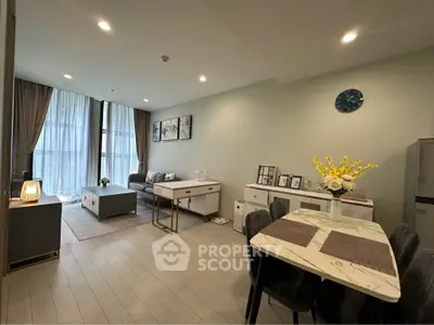 Modern open-plan living room and dining area with stylish decor and ample natural light