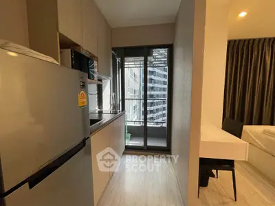 Modern apartment kitchen with sleek appliances and city view balcony
