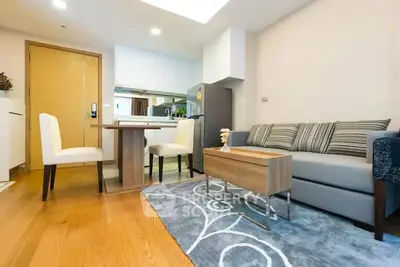 Modern open-plan living room with stylish furniture and wooden flooring