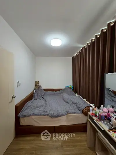 Cozy bedroom with modern decor and ample natural light