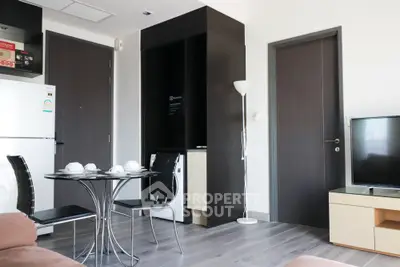 Modern apartment interior with dining area and TV setup