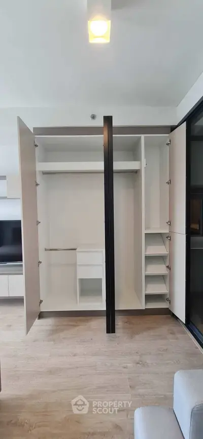 Spacious modern wardrobe with open doors in a stylish apartment interior