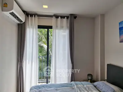 Cozy bedroom with balcony view and air conditioning in modern apartment