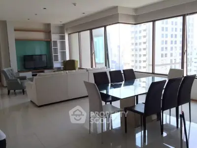 Spacious modern living and dining area with large windows and city view