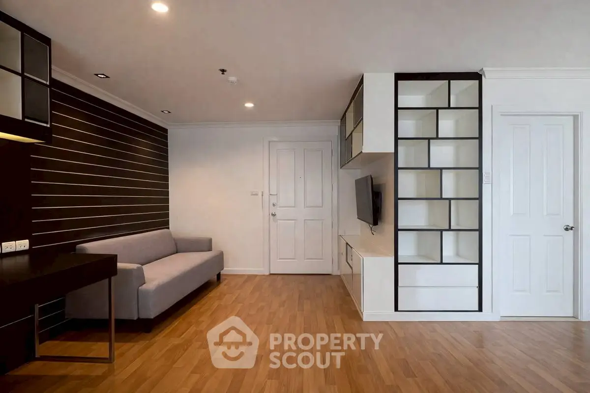 Modern living room with sleek built-in shelving and cozy sofa, perfect for stylish urban living.