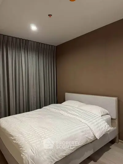 Modern bedroom with elegant design and cozy ambiance, featuring a comfortable bed and stylish curtains.