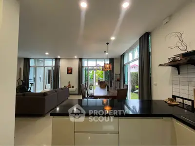 Spacious open-plan living and dining area with modern decor and garden view