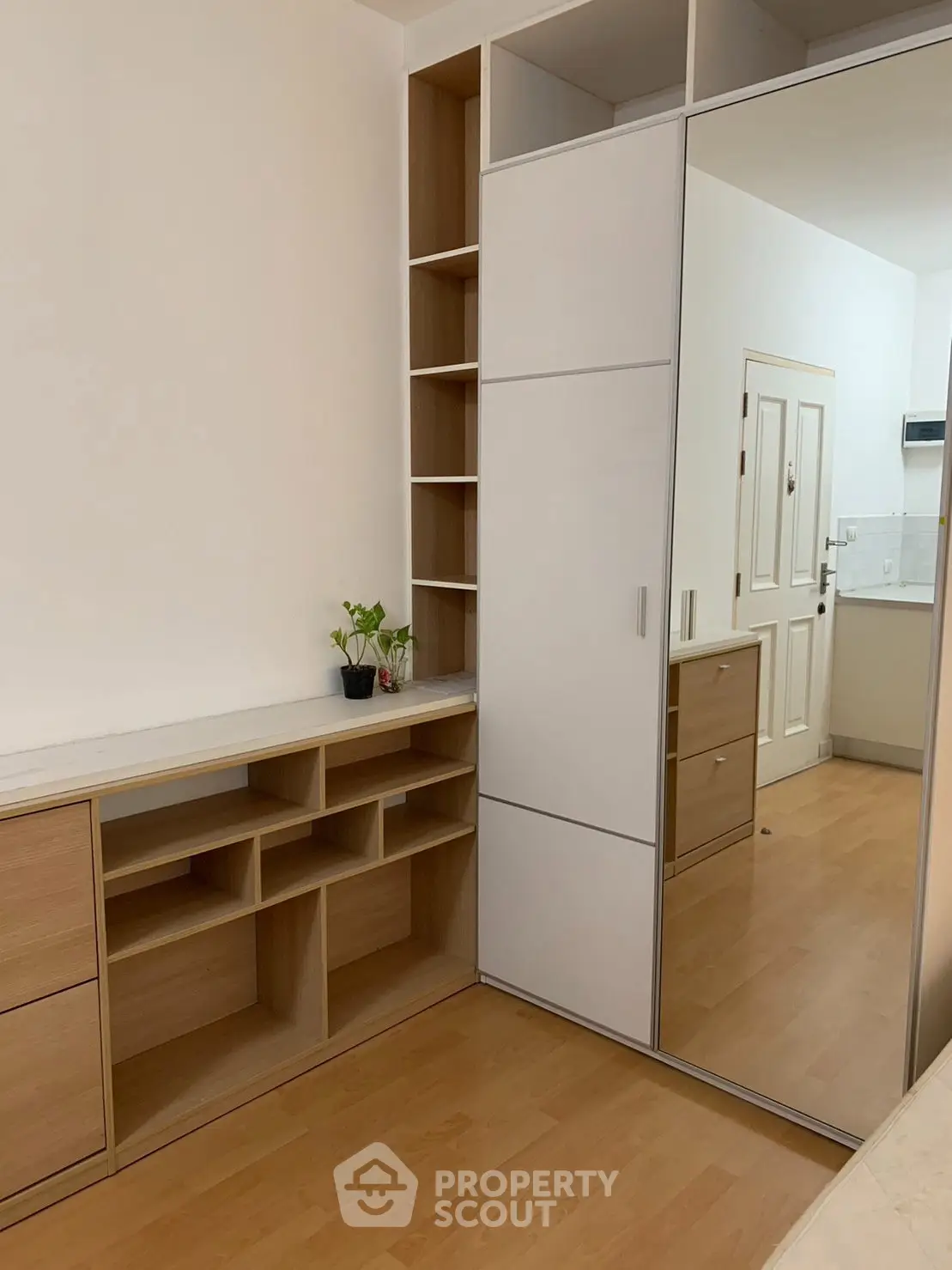 Modern bedroom with built-in storage and mirrored wardrobe doors