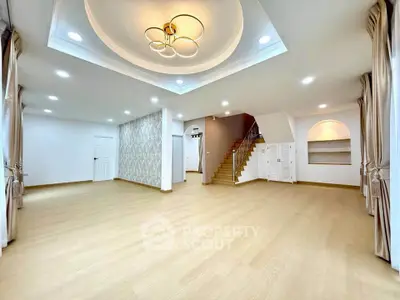 Spacious modern living room with elegant lighting and wooden flooring