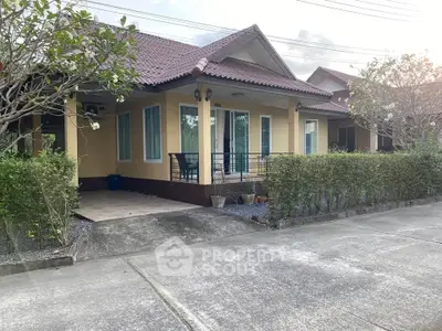Charming single-story home with lush greenery and inviting front porch in a serene neighborhood.