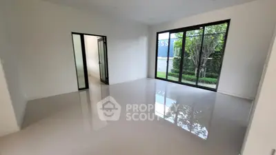 Spacious modern living room with large windows and garden view